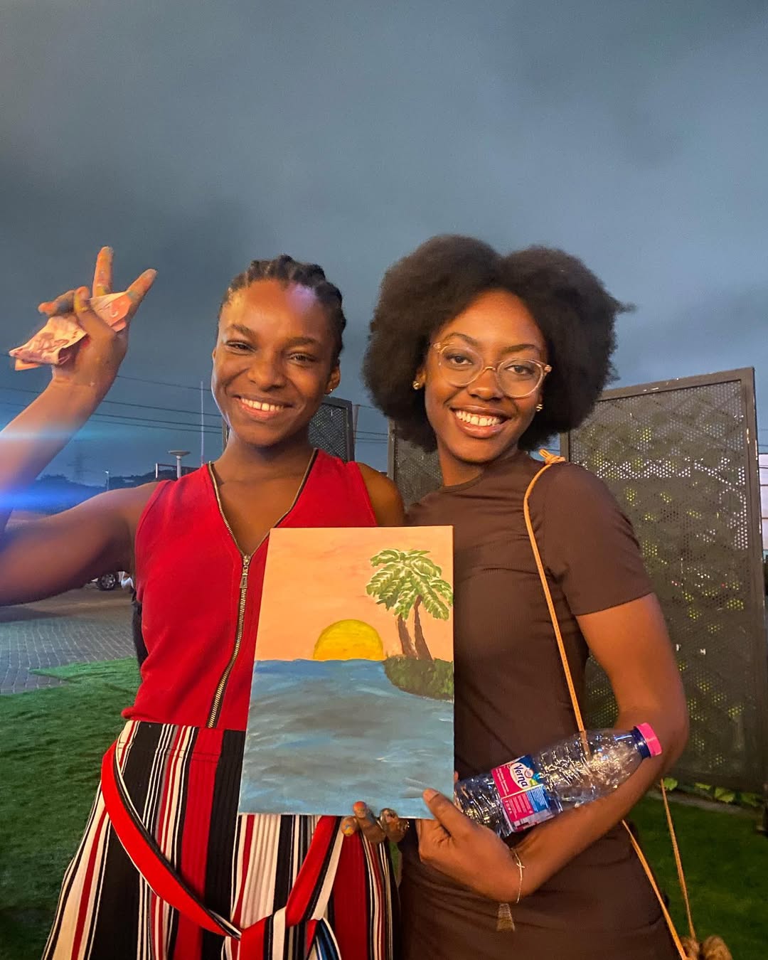 Two friends with their sunset canvases at dusk